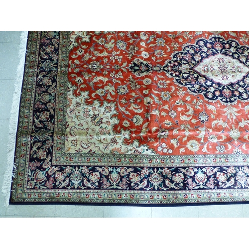 120 - A Qum design silk rug, decorated with a central medallion, surrounded and bordered by floral and bir... 