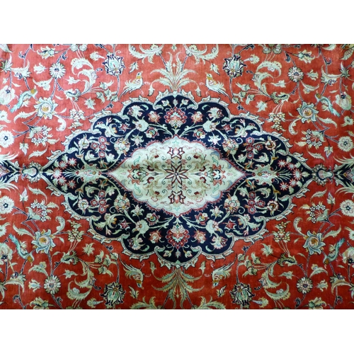 120 - A Qum design silk rug, decorated with a central medallion, surrounded and bordered by floral and bir... 
