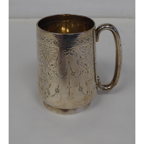 64 - A late Victorian silver Christening tankard with a hollow handle and bright-cut engraving&nbsp; indi... 