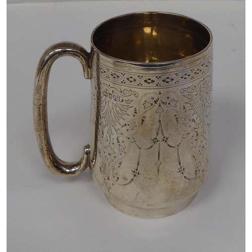 64 - A late Victorian silver Christening tankard with a hollow handle and bright-cut engraving&nbsp; indi... 