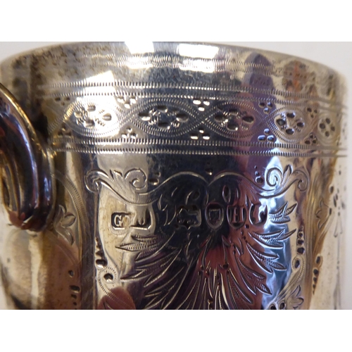 64 - A late Victorian silver Christening tankard with a hollow handle and bright-cut engraving&nbsp; indi... 