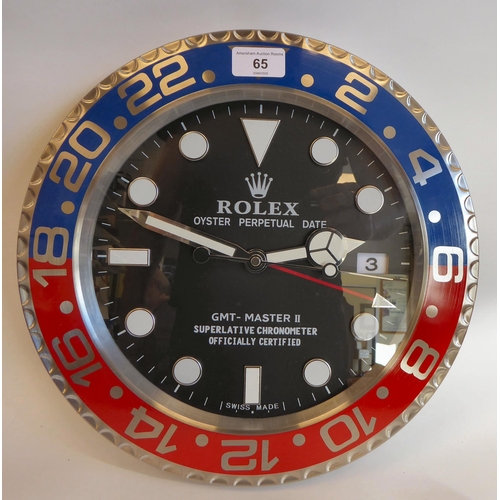 65 - A dealer display advertising wall timepiece for 'Rolex Oyster Perpetual', faced by a black baton dia... 