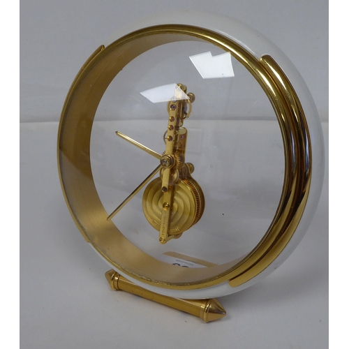 69 - A mid 20thC Jaeger Le Coultre gilt brass and cream coloured composition cased mantel timepiece, on a... 