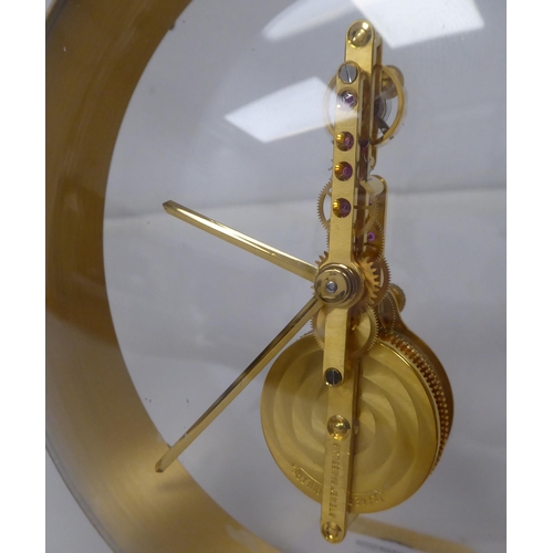 69 - A mid 20thC Jaeger Le Coultre gilt brass and cream coloured composition cased mantel timepiece, on a... 