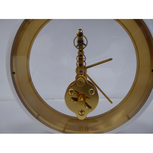 69 - A mid 20thC Jaeger Le Coultre gilt brass and cream coloured composition cased mantel timepiece, on a... 