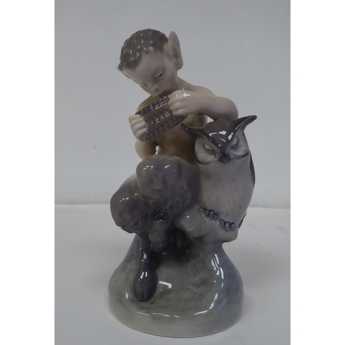 70 - A Royal Copenhagen porcelain figure, No.2107, a faun with an owl  6.25