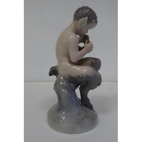 70 - A Royal Copenhagen porcelain figure, No.2107, a faun with an owl  6.25