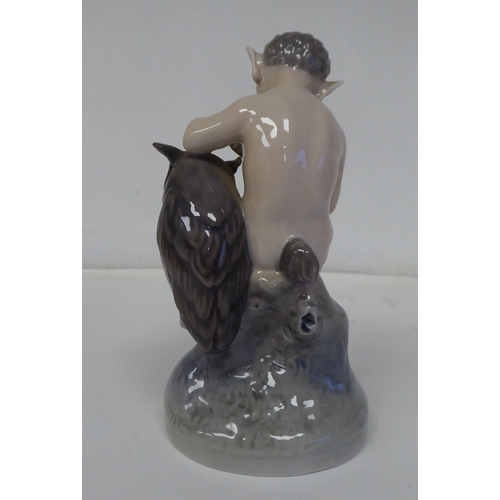 70 - A Royal Copenhagen porcelain figure, No.2107, a faun with an owl  6.25