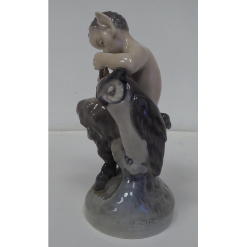 70 - A Royal Copenhagen porcelain figure, No.2107, a faun with an owl  6.25