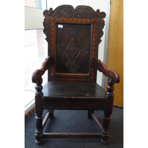 75 - An 17th/18thC oak wainscot chair, the panelled back with an inlaid border, set in an ornate diamond ... 