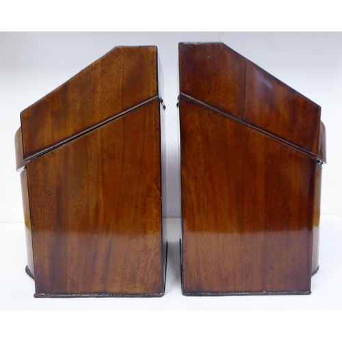 79 - A pair of Regency serpentine front, mahogany knife boxes with satin marquetry ornament on the angled... 