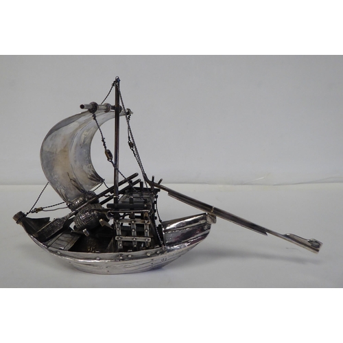 99 - A white metal model junk under sail with cargo  5.5