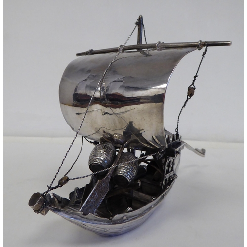 99 - A white metal model junk under sail with cargo  5.5