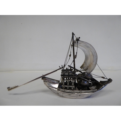 99 - A white metal model junk under sail with cargo  5.5