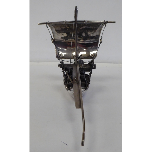 99 - A white metal model junk under sail with cargo  5.5