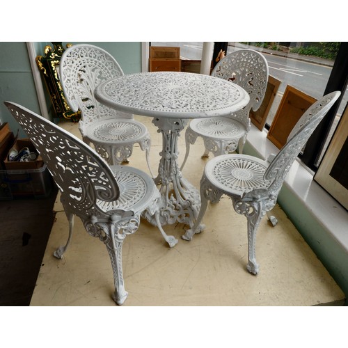 116 - A late Victorian, later white painted, five piece cast iron terrace set  comprising a table, ornamen... 