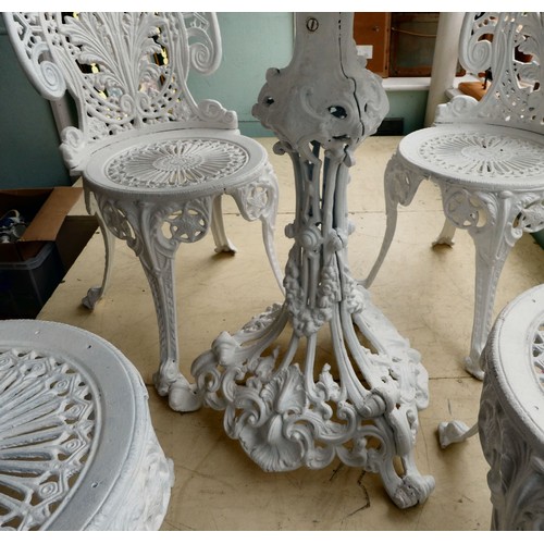 116 - A late Victorian, later white painted, five piece cast iron terrace set  comprising a table, ornamen... 