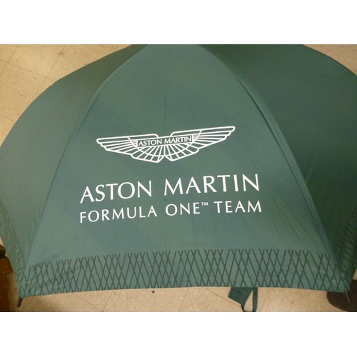 263 - An umbrella  inscribed for Aston Martin Formula One Team with protective cover