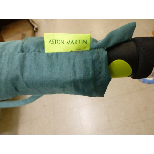 263 - An umbrella  inscribed for Aston Martin Formula One Team with protective cover