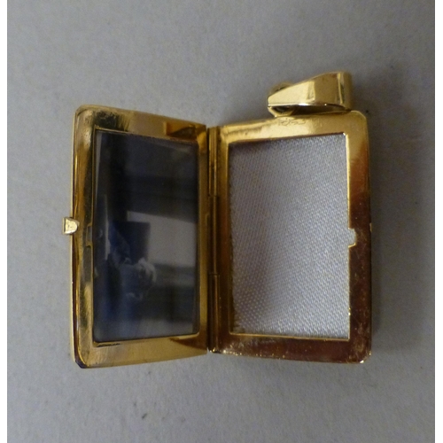 10 - An 18ct gold pendant locket&nbsp; (approx. weight 7 grams), on a 9ct gold chain (approx. 2.9 grams)