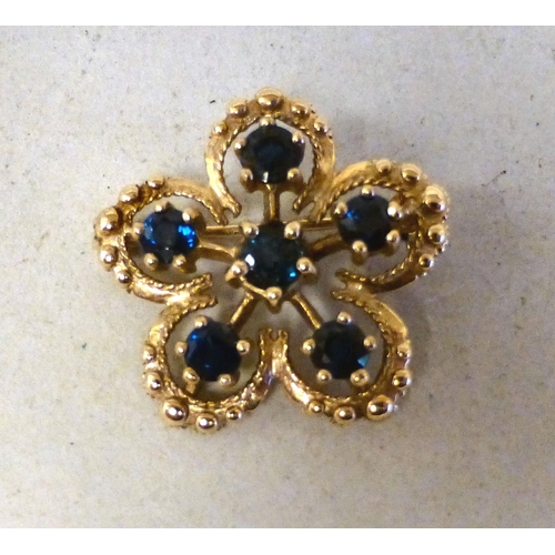 13 - A 9ct gold petal design brooch, set with sapphires  (approx. weight 5 grams)