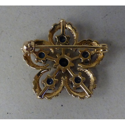 13 - A 9ct gold petal design brooch, set with sapphires  (approx. weight 5 grams)