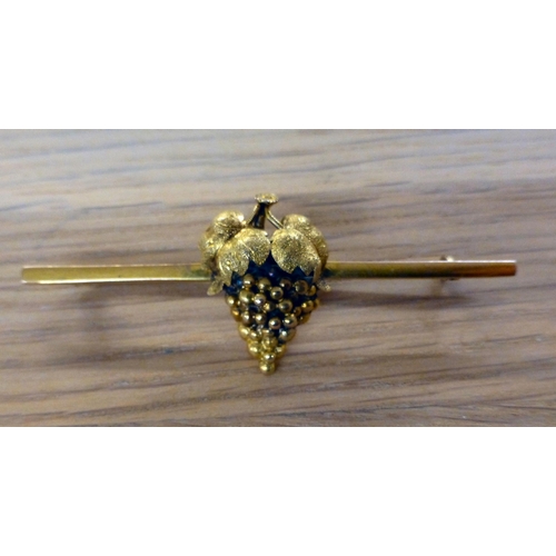 2 - A yellow metal bar brooch, surmounted by a bunch of grapes under foliage&nbsp; stamped 18ct verso&nb... 