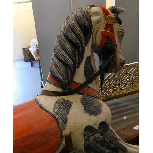 254 - A painted resin rocking horse, on a wooden trestle stand&nbsp; 50