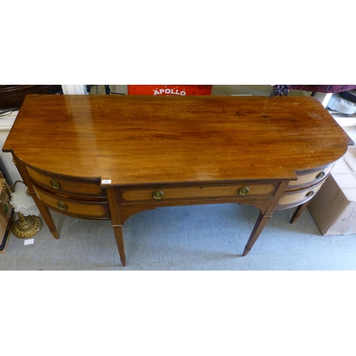 256 - An Edwardian string inlaid mahogany breakfront sideboard with an arrangement of four short/one long ... 
