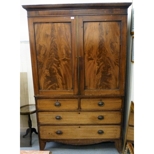 263 - A George III mahogany linen press with two doors, over two short/two long drawers, raised on bracket... 