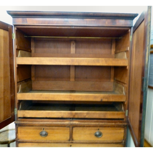 263 - A George III mahogany linen press with two doors, over two short/two long drawers, raised on bracket... 