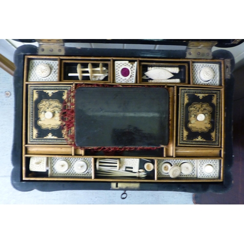 265 - A late Victorian chinoiserie design, black lacquered and gilded work table, the hinged lid enclosing... 