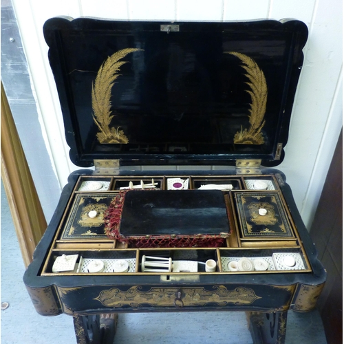 265 - A late Victorian chinoiserie design, black lacquered and gilded work table, the hinged lid enclosing... 