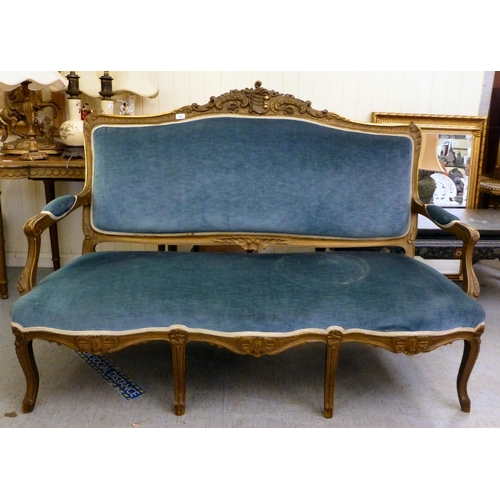 266 - A suite of late 19thC gilt overpainted rococo design furniture, comprising an open arm settee  63