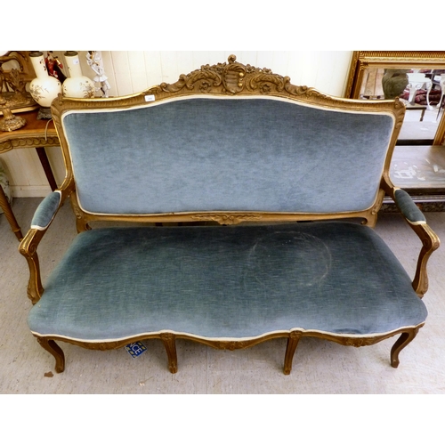 266 - A suite of late 19thC gilt overpainted rococo design furniture, comprising an open arm settee  63