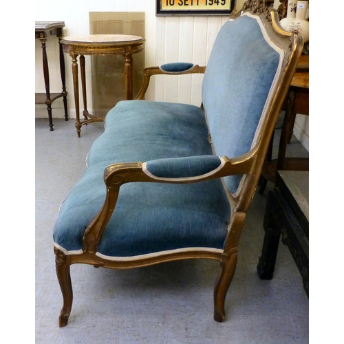 266 - A suite of late 19thC gilt overpainted rococo design furniture, comprising an open arm settee  63