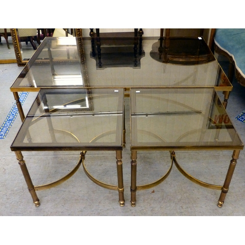 274 - A modern lacquered brass coffee table with a smoked glass top, raised on reeded legs&nbsp; 17