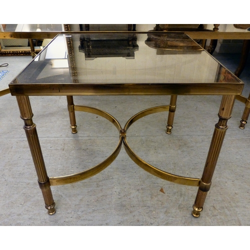 274 - A modern lacquered brass coffee table with a smoked glass top, raised on reeded legs&nbsp; 17