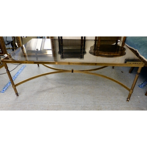 274 - A modern lacquered brass coffee table with a smoked glass top, raised on reeded legs&nbsp; 17