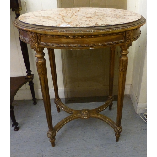 275 - A modern gilt overpainted lamp table, the lozenge shaped marble top raised on fluted, tapered legs, ... 