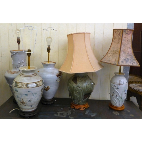 286 - Pottery table lamps: to include a Chinese inspired example, decorated in relief with flora&nbsp; 14