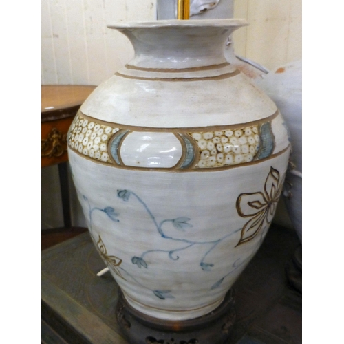 286 - Pottery table lamps: to include a Chinese inspired example, decorated in relief with flora&nbsp; 14