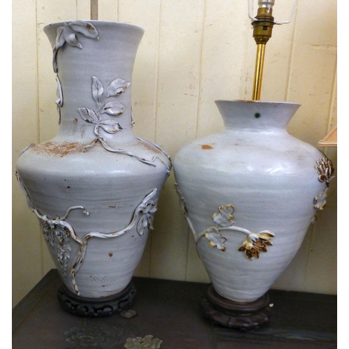 286 - Pottery table lamps: to include a Chinese inspired example, decorated in relief with flora&nbsp; 14