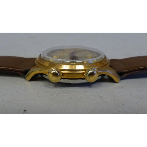 29 - A Mondaine gold plated manual alarm watch, faced by a baton and Arabic dial