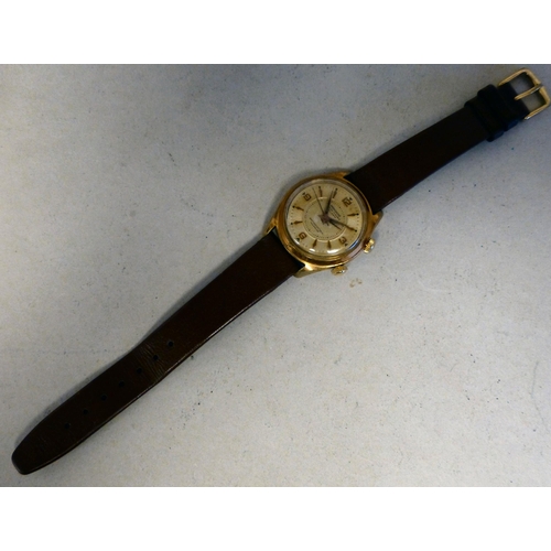29 - A Mondaine gold plated manual alarm watch, faced by a baton and Arabic dial