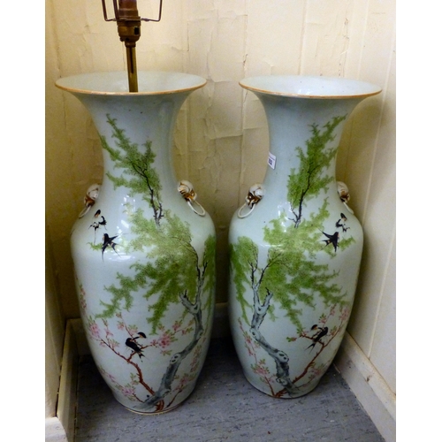 292 - A pair of mid 20thC Chinese porcelain vases, decorated with birds and flora&nbsp; 23