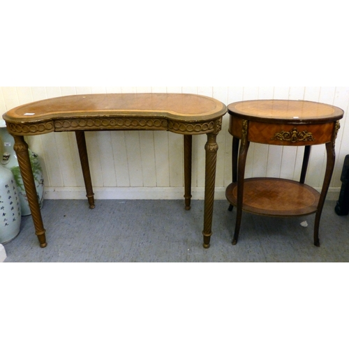 294 - A modern gilt overpainted kidney shaped table, the showwood top raised on spiral, fluted legs and bu... 