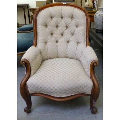 300 - A late 19thC mahogany framed salon chair with a cream fabric upholstered back and seat, raised on ca... 