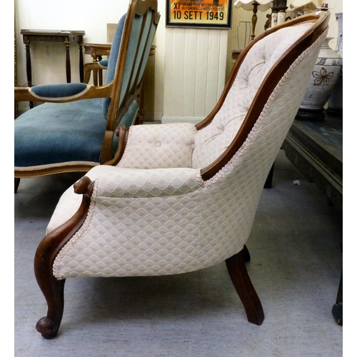 300 - A late 19thC mahogany framed salon chair with a cream fabric upholstered back and seat, raised on ca... 