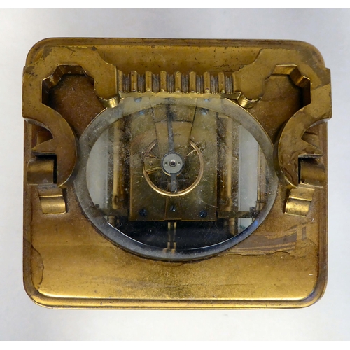 33 - A lacquered brass travel timepiece with bevelled glass panels; the movement faced by an enamelled Ro... 